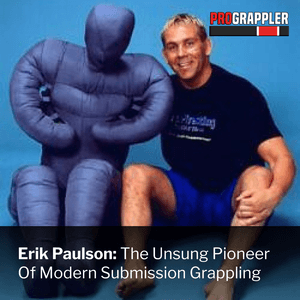 Erik Paulson posing with a grappling dummy