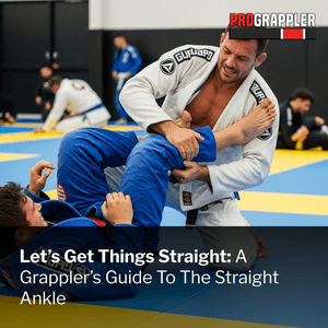 Two men grappling in gi's while one goes for a straight ankle lock submission